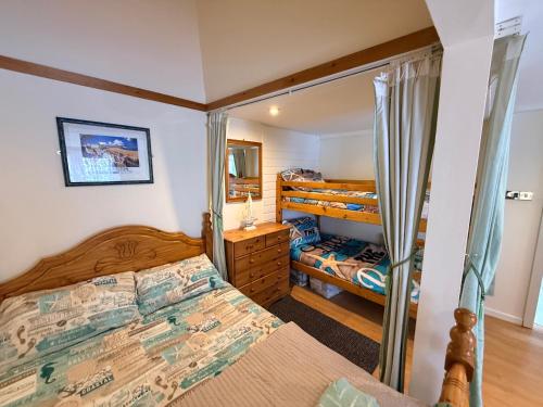 a bedroom with two beds and a mirror at Casa G in Bridlington