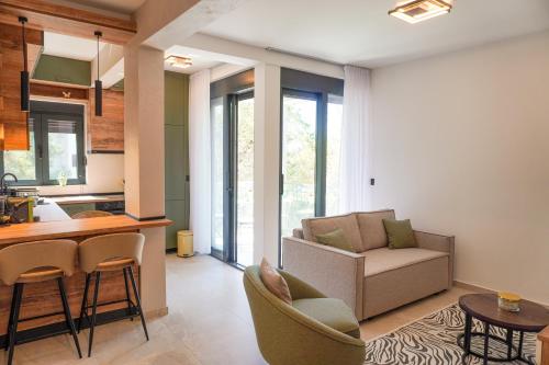 a kitchen and living room with a couch and a table at Casa Oliva Tivat in Tivat