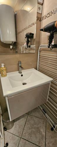 a bathroom with a white sink and a mirror at Studio Cozy Paris & Disneyland in Bry-sur-Marne