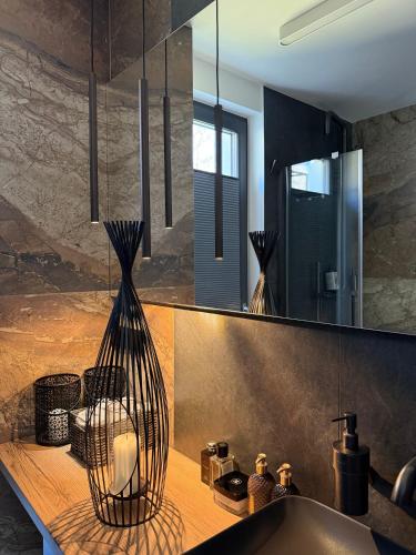 a bathroom with a sink and a large mirror at Ostoja Dębowa Studnica in Studnica