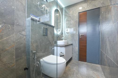 a bathroom with a toilet and a shower and a sink at FabHotel The White Cliff Inn - Near Max Hospital Saket in New Delhi