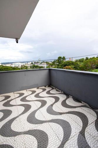 a balcony with a snake pattern on the floor at Studio Funcional c Wifi perto do Centro Itabuna in Itabuna