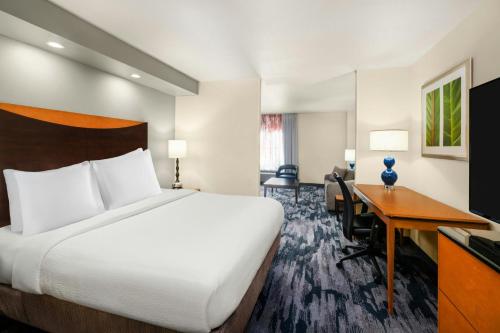 a hotel room with a bed and a desk at Fairfield Inn & Suites by Marriott Denver Aurora/Parker in Foxfield