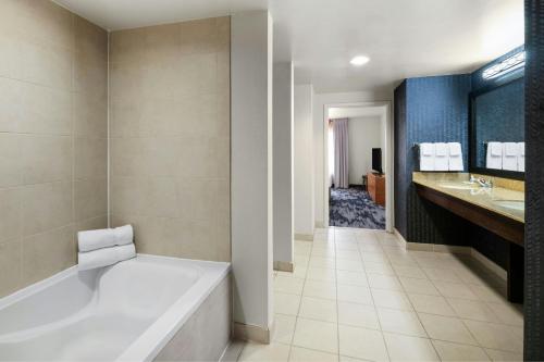 a bathroom with a white tub and a sink and a tub at Fairfield Inn & Suites by Marriott Denver Aurora/Parker in Foxfield