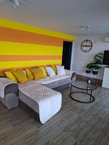 a living room with two couches and a colorful wall at Sap Pool House in Ritopek