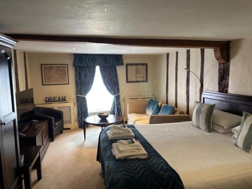a hotel room with a bed and a couch at Sams Wine Bar Harwich ltd in Harwich