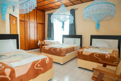a room with two beds and a window at Kibeho Pilgrimage Center in Giseke