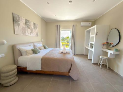 a bedroom with a large bed and a window at Irene Studios in Arillas