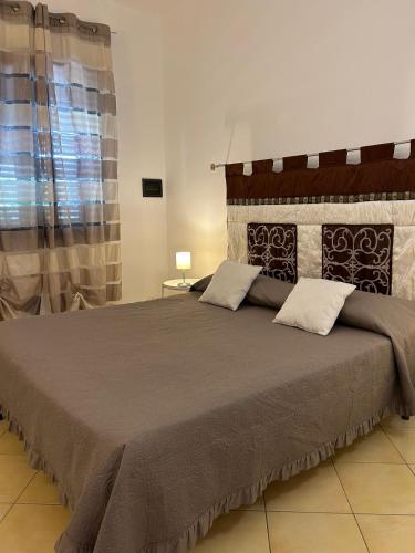 a bedroom with a large bed in a room at Grace's Place in Scopello