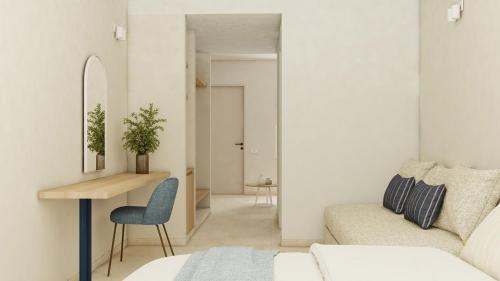 ein Wohnzimmer mit einem Bett, einem Tisch und einem Sofa in der Unterkunft Captains De Luxe in Argassi