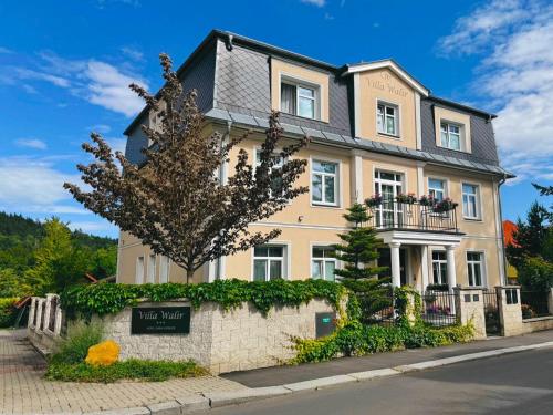 a large house with a sign in front of it at Villa Walir - Spa Hotel Garni SUPERIOR in Mariánské Lázně
