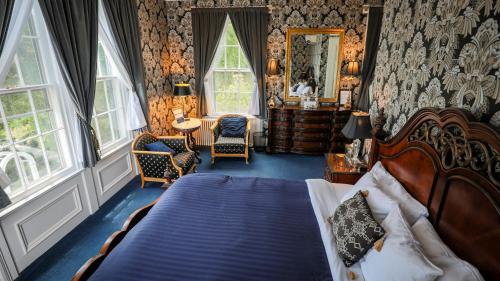 a bedroom with a bed and a mirror in it at Inn at Taughannock Falls in Ithaca