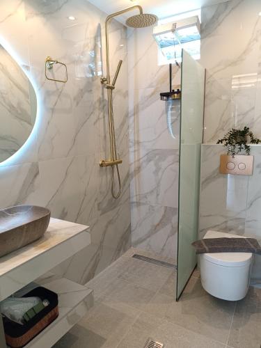 a bathroom with a shower and a sink at Th Tsimas Luxury studio 4 in Skala Potamias