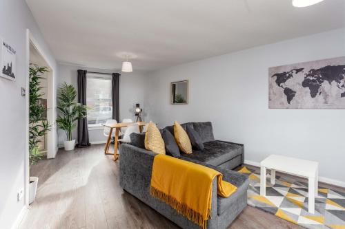 a living room with a couch and a table at Ayr Retreat - Donnini Apartments in Ayr