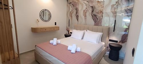 a bedroom with a bed with two candles on it at Th Tsimas Luxury studio 4 in Skala Potamias