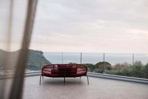 a red bench sitting in front of a window at Villa La Biancolilla in Garda