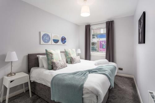 a bedroom with a large bed and a window at Ayr Retreat - Donnini Apartments in Ayr
