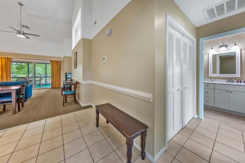 a living room with a bench and a kitchen at 2 Bedroom Condo on Lake with Jacuzzi in New Bern