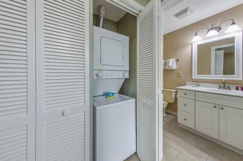 a bathroom with a toilet and a sink at 2 Bedroom Condo on Lake with Jacuzzi in New Bern