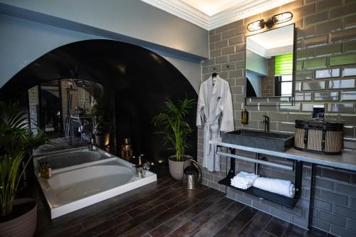 a bathroom with a tub and a sink and a mirror at The Gyle - Kings Cross St Pancras, London in London