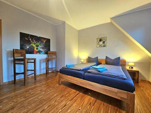 a bedroom with a bed and a table with a chair at Selker Noor Apartments - 1,4 ha Naturpark, privater Terrasse, Bachlauf an der Selker Wassermühle in Schleswig