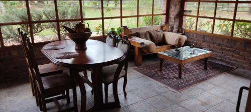 a living room with a table and a couch at Tu Casa - Hotel Rural in Sopó