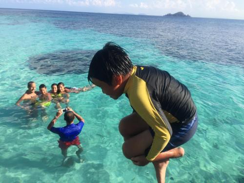 a group of people in the water in the ocean at BuBu Villa in Perhentian Island