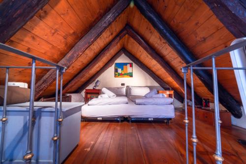 a bedroom with two beds in a attic at Centovalli Rustic near Locarno in Intragna