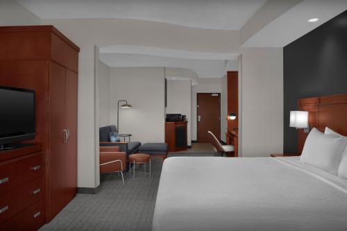 a hotel room with a bed and a living room at Courtyard by Marriott San Antonio SeaWorld Westover Hills in San Antonio