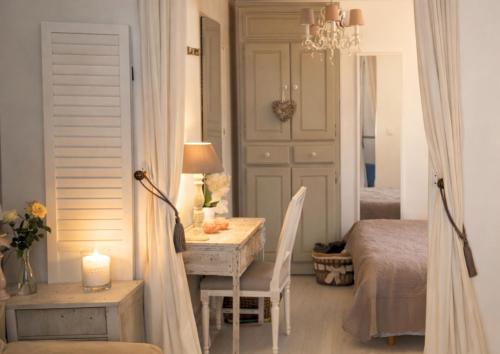 a bedroom with a bed and a table with a candle at Maison de Thau in Mèze