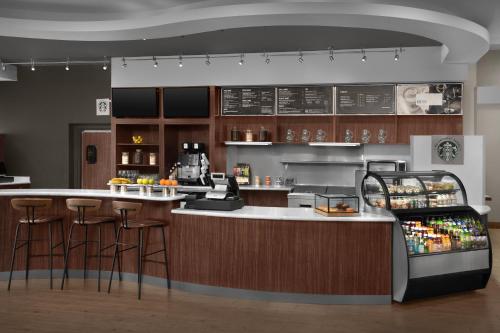 a kitchen with a counter with bar stools at Courtyard by Marriott San Antonio SeaWorld Westover Hills in San Antonio