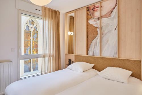 a bedroom with a bed with a painting on the wall at MAISON SAINT CHARLES - ASSOCIATION HABITAT et HUMANISME ILE DE FRANCE in Paris