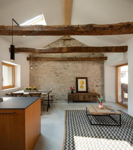 a living room with a brick wall and a table at Charming Rustico Losone near Locarno in Losone