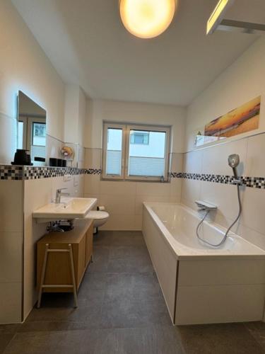 a bathroom with a tub and a sink at See you! in Pouch