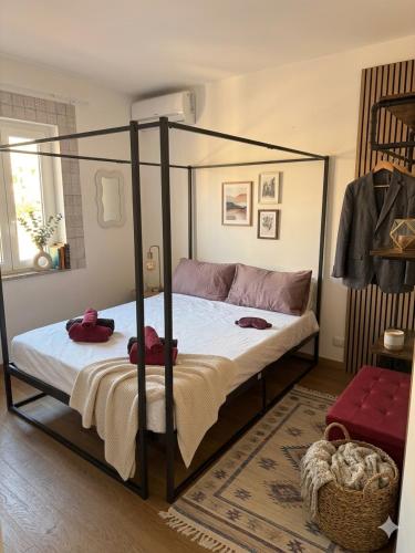 a bedroom with a four poster bed with towels on it at Stella Sea House2 in Torvaianica