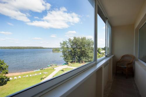 a room with a large window with a view of the water at AMAKS Valdaiskie Zori in Valday