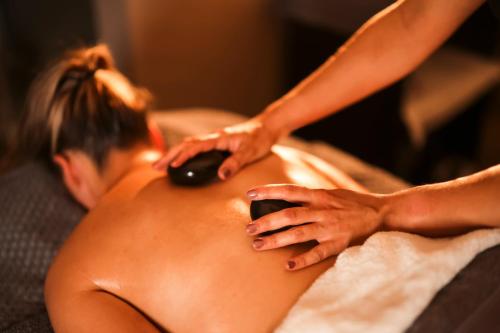 a woman getting a back massage from a therapist at The Kinmel & Kinspa in Abergele