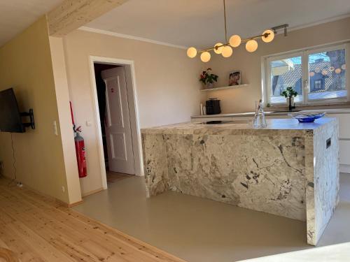 a kitchen with a stone counter in a room at Rainbow Bungalow in Butgenbach