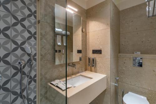 a bathroom with a sink and a shower at Clarks Inn Bokaro in Bokāro