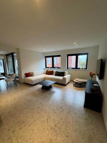 a large living room with two couches and windows at The Corner-LISETTE in Oedelem