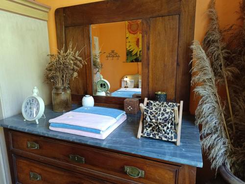 a bedroom with two beds and a dresser with a mirror at B&B Candalla in Camaiore