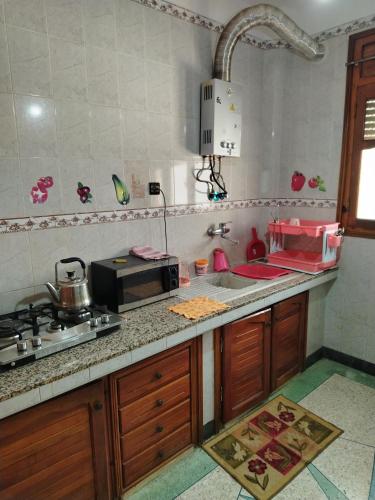 a kitchen with a sink and a stove and a counter top at sweet Atlas hollydays in Azrou