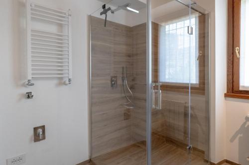 a bathroom with a shower with a glass door at Ca da Smarè - Where Time stands Still in Someraro