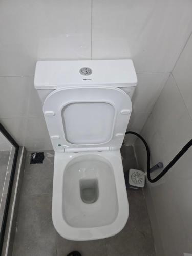 a bathroom with a white toilet in a stall at Transit Care Hotel in Port Harcourt