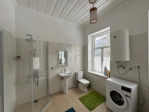 a bathroom with a shower toilet and a sink at Authentic house with a huge garden in Utsera