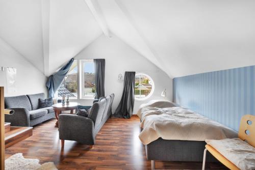 a bedroom with a bed and a couch at Villa Stavanger 5 bedrooms 5 bathrooms and large swimming pool in Stavanger