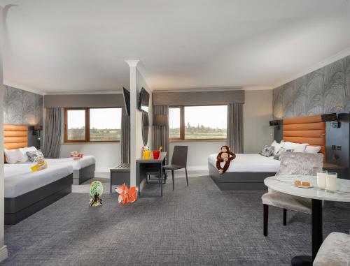 a hotel room with two beds and a desk at Diamond Coast Hotel in Enniscrone