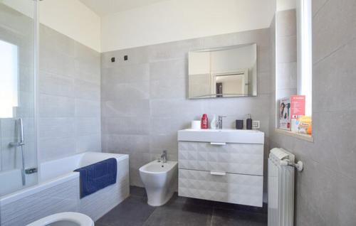 a white bathroom with a sink and a toilet at Oltremare - casa vacanze Agropoli appartamento rooms in Agropoli