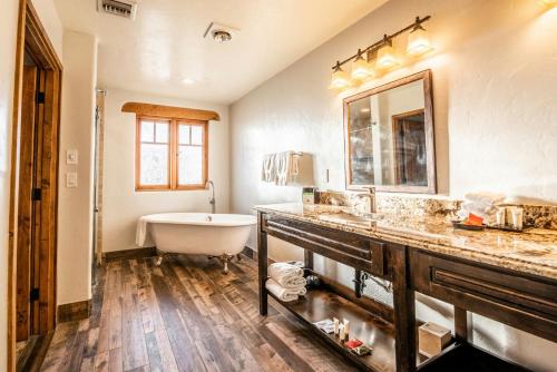 a bathroom with a bath tub and a sink and a bath tub at Tanque Verde Guest Ranch in Tucson