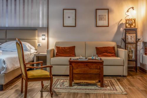 a living room with a couch and a table and a bed at Casa Lanzara - Dimora Storica nel cuore del Pollino in Morano Calabro